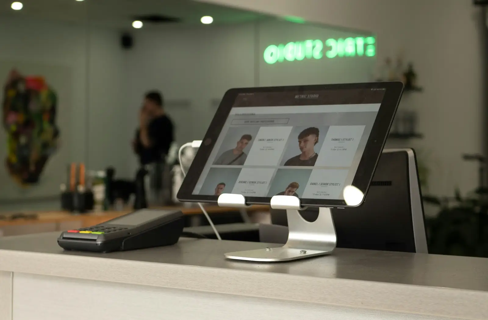 A tablet at a reception desk showing customer records