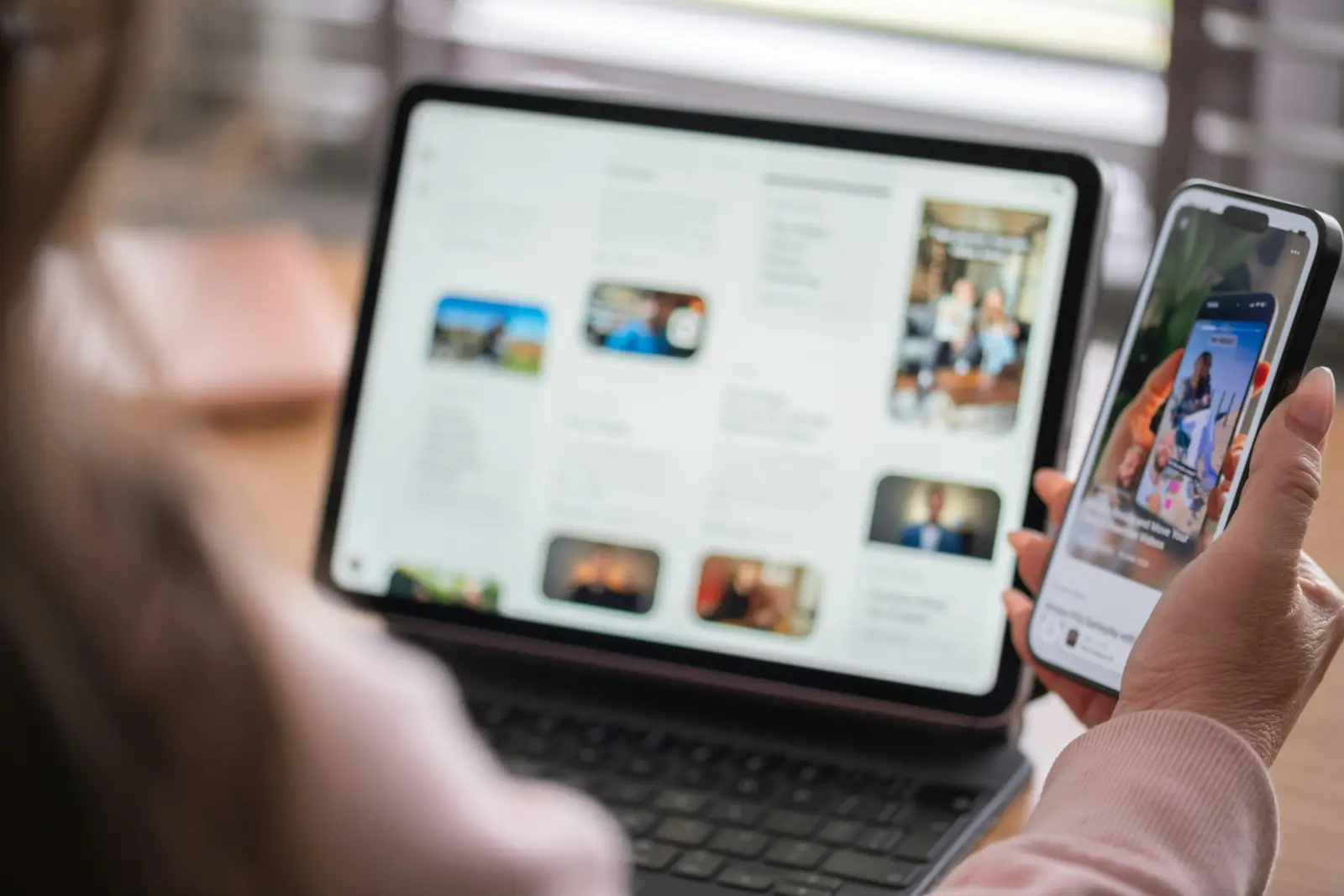 Someone checks a store from their phone while browsing the catalogue on a tablet